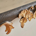 A rectangular mirror with an ebonised and parcel gilt carved frame