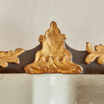 A rectangular mirror with an ebonised and parcel gilt carved frame