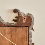 A rectangular mirror with an ebonised and parcel gilt carved frame