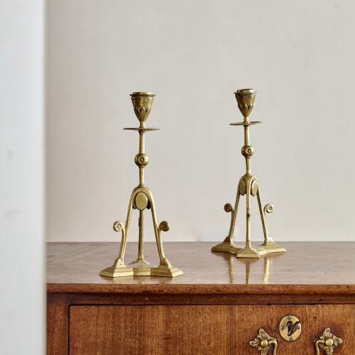A pair of Aesthetic Movement brass candlesticks