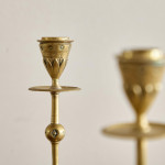 A pair of Aesthetic Movement brass candlesticks