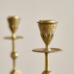 A pair of Aesthetic Movement brass candlesticks