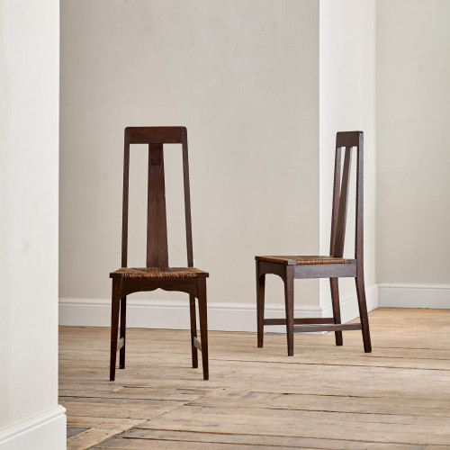 A pair of Arts and Crafts stained oak high back side chairs