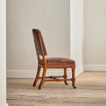 A Reformed Gothic oak upholstered side chair covered in the original red leather
