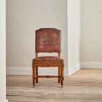 A Reformed Gothic oak upholstered side chair covered in the original red leather
