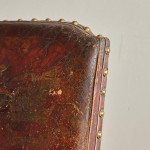 A Reformed Gothic oak upholstered side chair covered in the original red leather