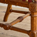 A Reformed Gothic oak upholstered side chair covered in the original red leather