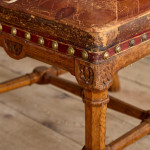 A Reformed Gothic oak upholstered side chair covered in the original red leather