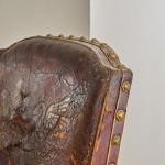 A Reformed Gothic oak upholstered side chair covered in the original red leather