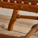 A Reformed Gothic oak upholstered side chair covered in the original red leather