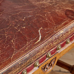 A Reformed Gothic oak upholstered side chair covered in the original red leather