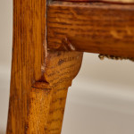 A Reformed Gothic oak upholstered side chair covered in the original red leather