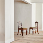 A pair of Regency oak hall chairs in the manner of George Bullock (1777-1818)