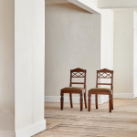 A pair of Regency oak hall chairs in the manner of George Bullock (1777-1818)