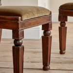 A pair of Regency oak hall chairs in the manner of George Bullock (1777-1818)