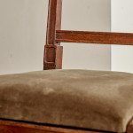 A pair of Regency oak hall chairs in the manner of George Bullock (1777-1818)