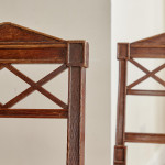 A pair of Regency oak hall chairs in the manner of George Bullock (1777-1818)