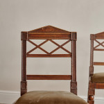 A pair of Regency oak hall chairs in the manner of George Bullock (1777-1818)