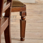 A pair of Regency oak hall chairs in the manner of George Bullock (1777-1818)