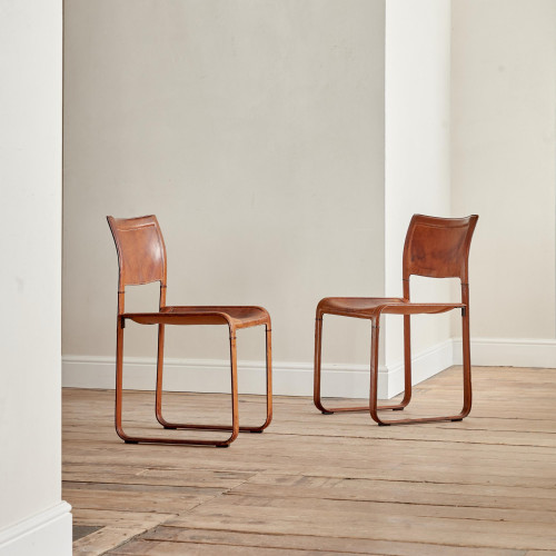A pair of early leather clad side chairs by Matteo Grassi