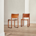 A pair of early leather clad side chairs by Matteo Grassi
