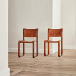 A pair of early leather clad side chairs by Matteo Grassi