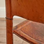 A pair of early leather clad side chairs by Matteo Grassi