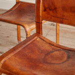 A pair of early leather clad side chairs by Matteo Grassi