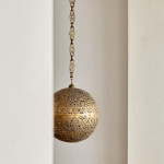 A large brass shadow ball pendant