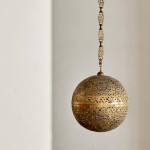 A large brass shadow ball pendant