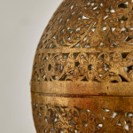 A large brass shadow ball pendant