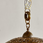 A large brass shadow ball pendant