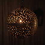 A large brass shadow ball pendant