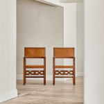 A pair of Arts and Crafts oak and leather armchairs