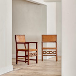 A pair of Arts and Crafts oak and leather armchairs
