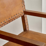 A pair of Arts and Crafts oak and leather armchairs