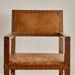 A pair of Arts and Crafts oak and leather armchairs