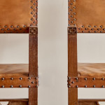 A pair of Arts and Crafts oak and leather armchairs