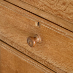 An Arts & Crafts limed oak cabinet by Ambrose Heal for Heal's