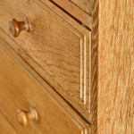 An Arts & Crafts limed oak cabinet by Ambrose Heal for Heal's