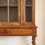 An unusual William & Mary style burr oak and seaweed marquetry glazed cabinet on stand
