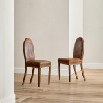 A pair of Art Deco beech and leather upholstered side chairs in the manner of Poul Follot (1877 - 1941)