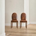 A pair of Art Deco beech and leather upholstered side chairs in the manner of Poul Follot (1877 - 1941)