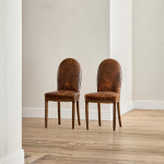 A pair of Art Deco beech and leather upholstered side chairs in the manner of Poul Follot (1877 - 1941)