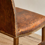 A pair of Art Deco beech and leather upholstered side chairs in the manner of Poul Follot (1877 - 1941)