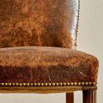 A pair of Art Deco beech and leather upholstered side chairs in the manner of Poul Follot (1877 - 1941)