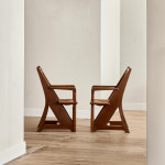 A pair of Arts & Crafts oak and rush elbow chairs
