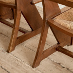 A pair of Arts & Crafts oak and rush elbow chairs