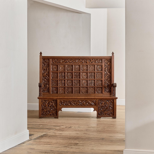 A fine Arts & Crafts carved oak settle in the manner of Bruce Talbert (1838 - 1881)