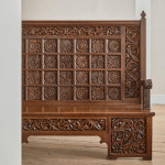 A fine Arts & Crafts carved oak settle in the manner of Bruce Talbert (1838 - 1881)
